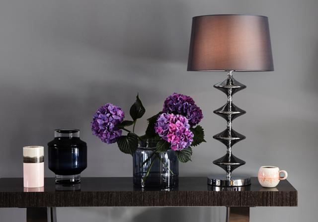 Flowers with console table and lamp.
