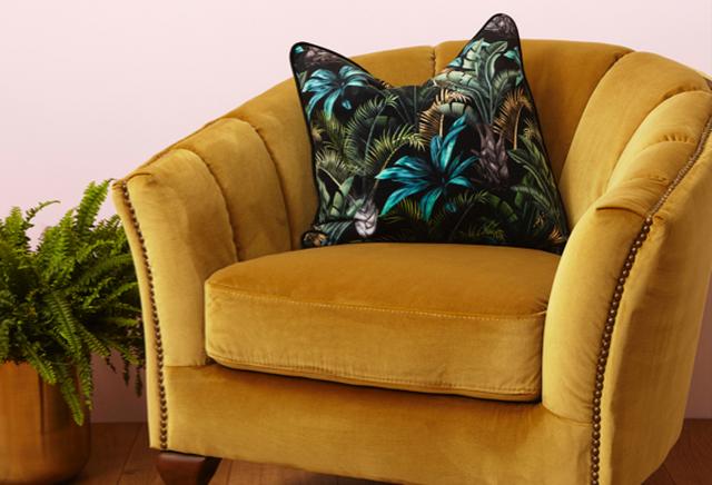 Botanical cushion on mustard armchair