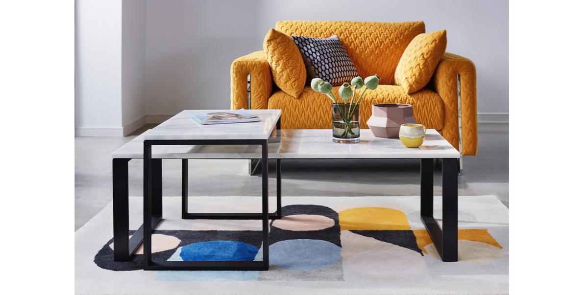 Quilted mustard chair with marble coffee table.