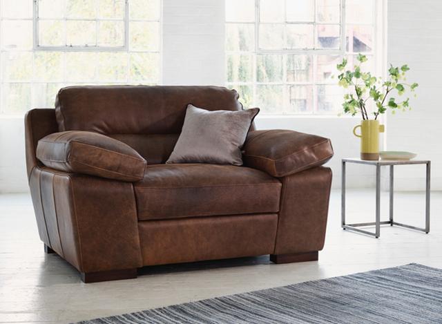 Distressed brown leather relaxed snuggler chair
