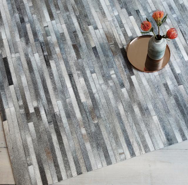 Hand stitched leather striped rug in light grey