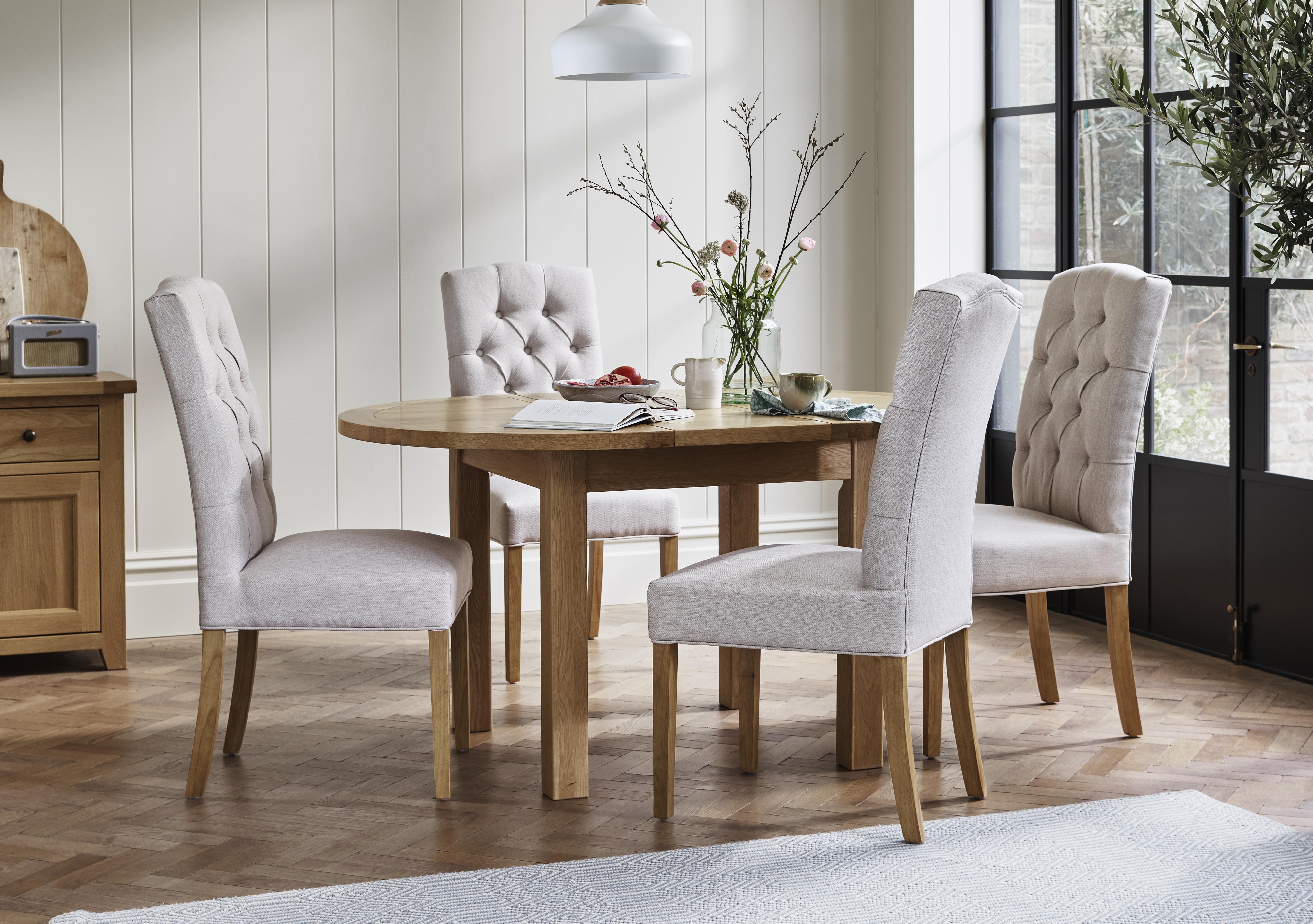 California Solid Oak Round Extending Table and 4 Button Back Upholstered Chairs in  on Furniture Village