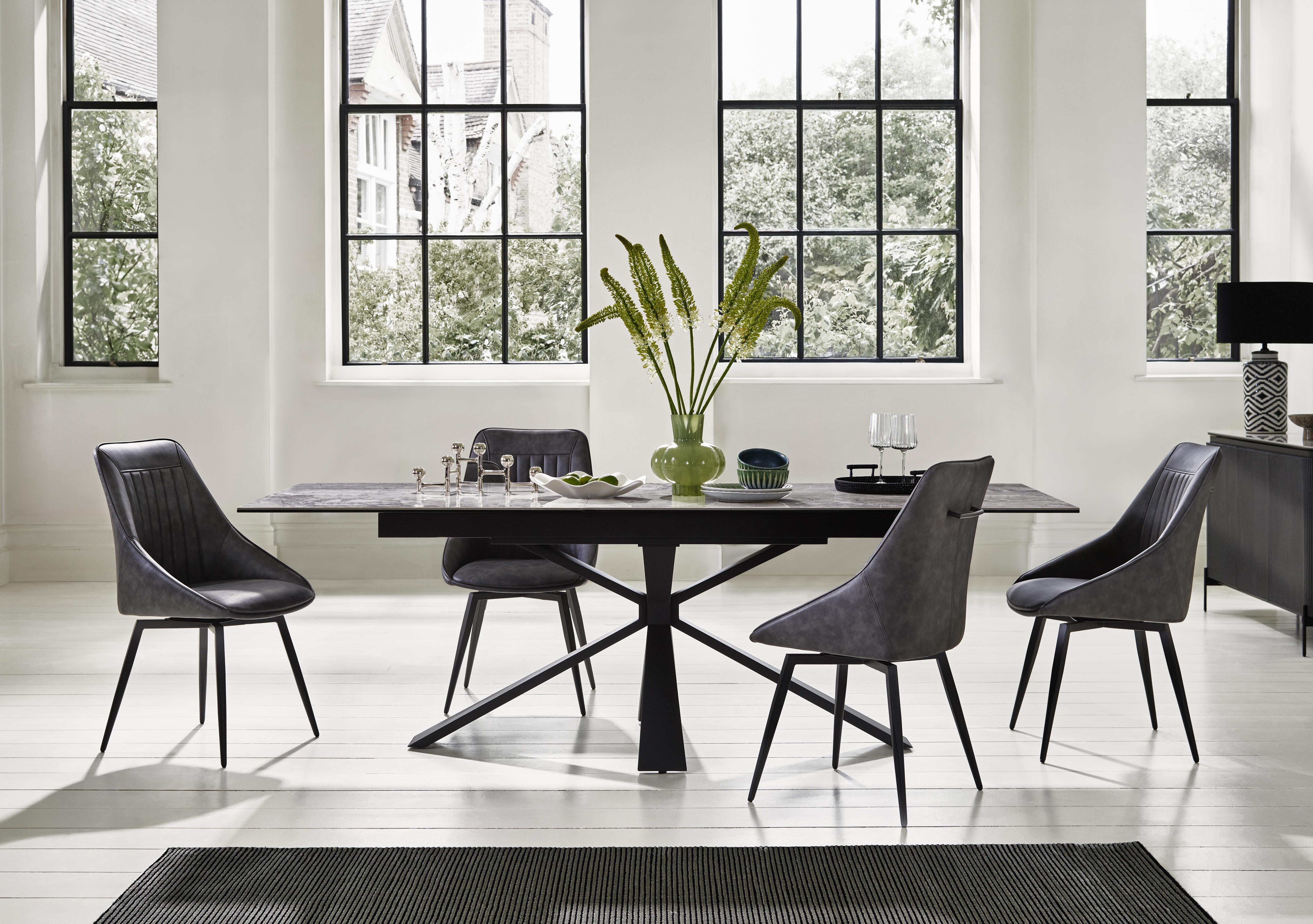Crete Large Extending Dining Table and 4 Faux Leather Swivel Dining Chairs in  on Furniture Village