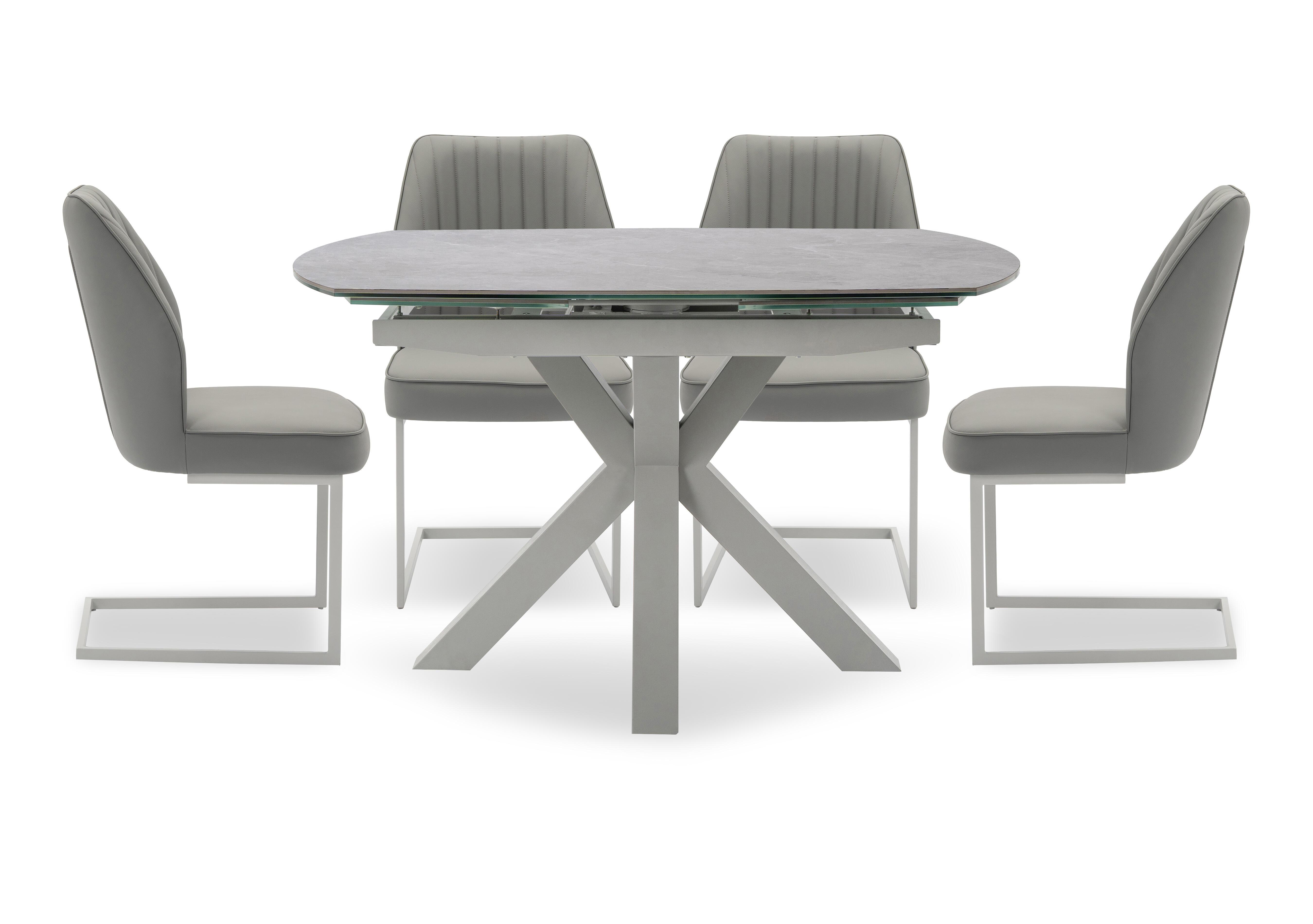 Fumo Swivel Extending Dining Table and 4 Faux Leather Cantilever Dining Chairs in  on Furniture Village