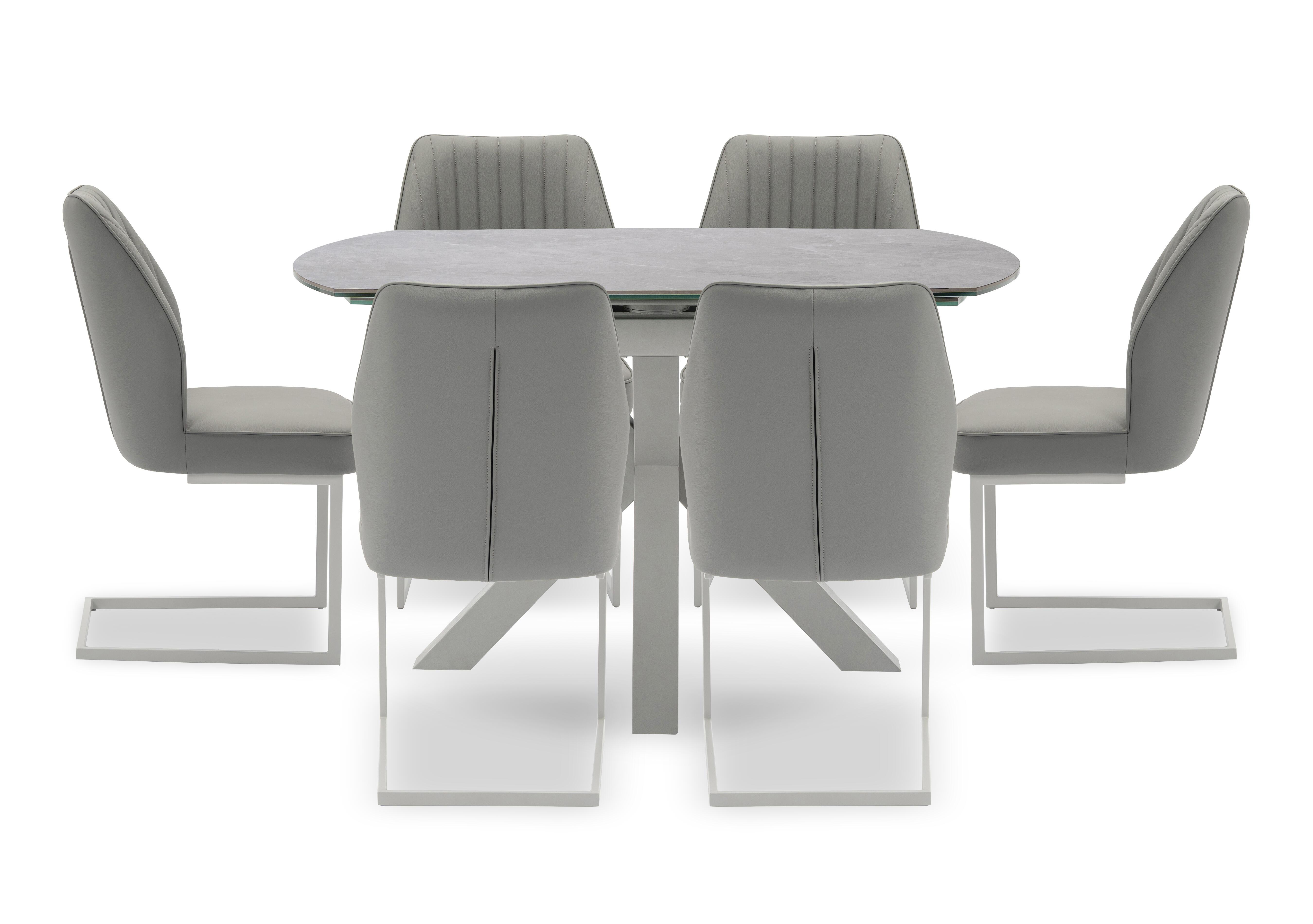 Fumo Swivel Extending Dining Table and 6 Faux Leather Cantilever Dining Chairs in  on Furniture Village