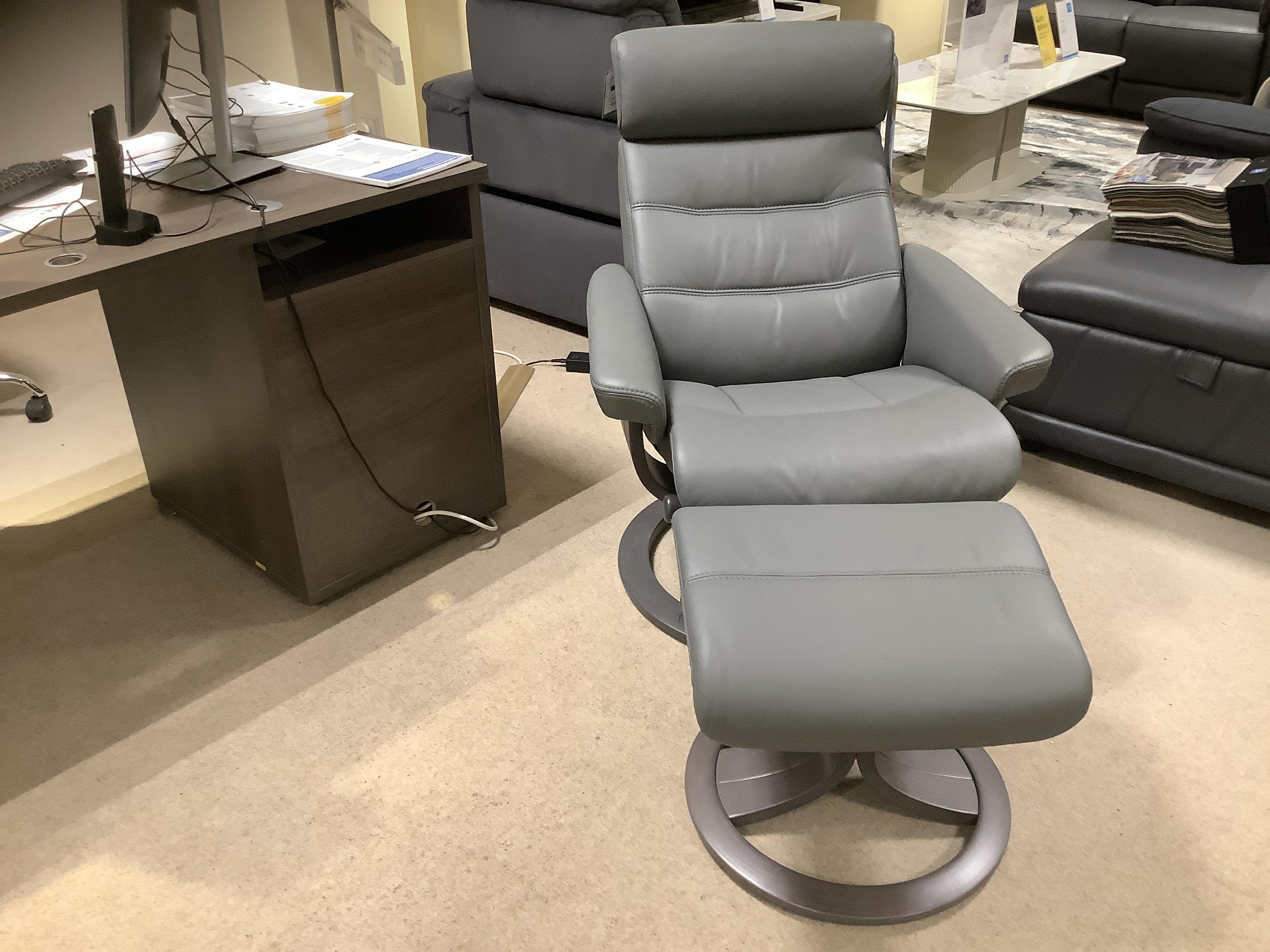 Odense medium leather swivel recliner chair and stool in  on Furniture Village