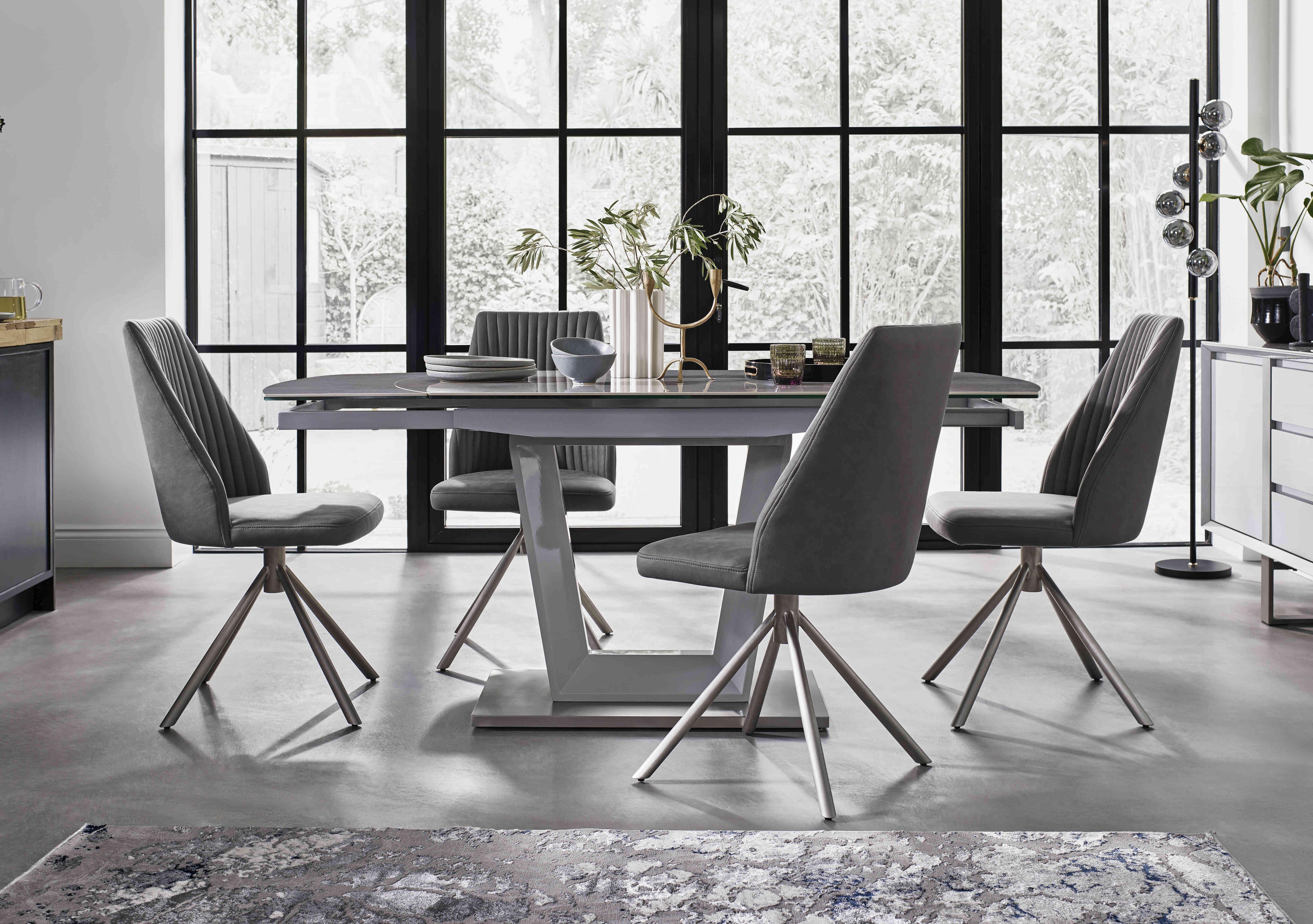 Grigio Swivel Extending Dining Table with 4 Swivel Dining Chairs in  on Furniture Village