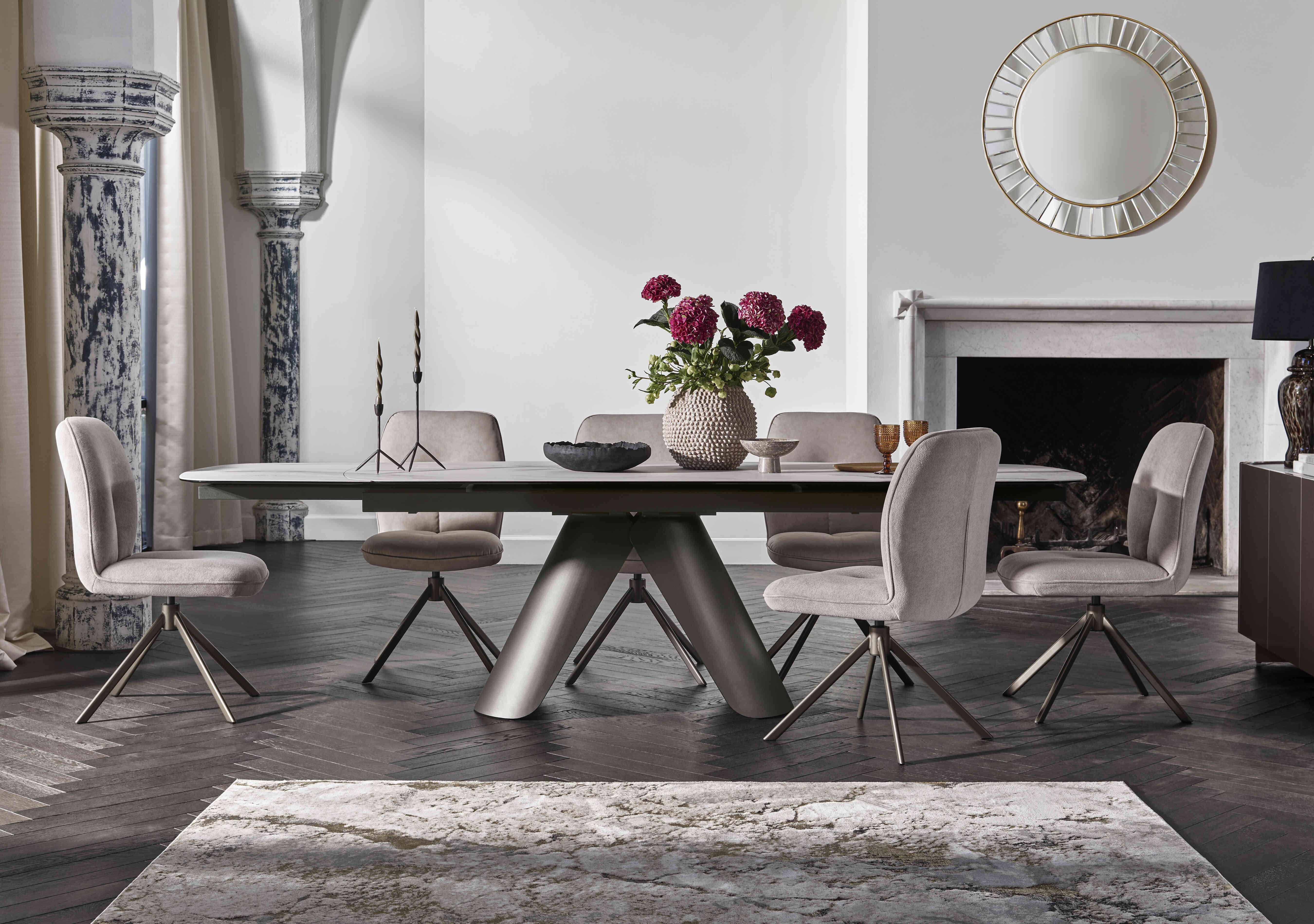 Perla Large Extending Dining Table and 6 Fabric Swivel Dining Chairs in  on Furniture Village