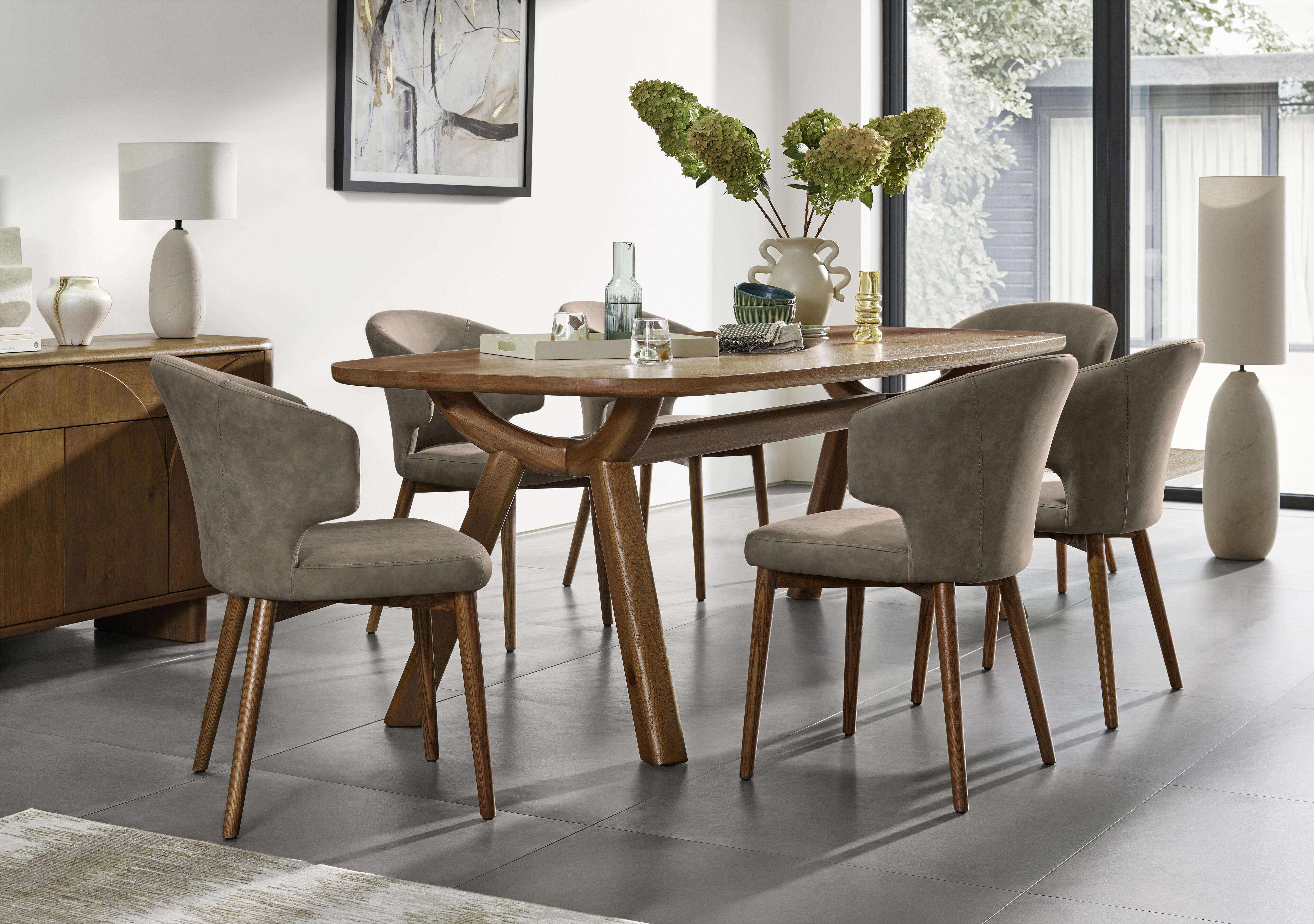 Pien Large Boat Shaped Oak Fixed Dining Table and 6 Faux Leather Dining Chairs with Wooden Legs in  on Furniture Village