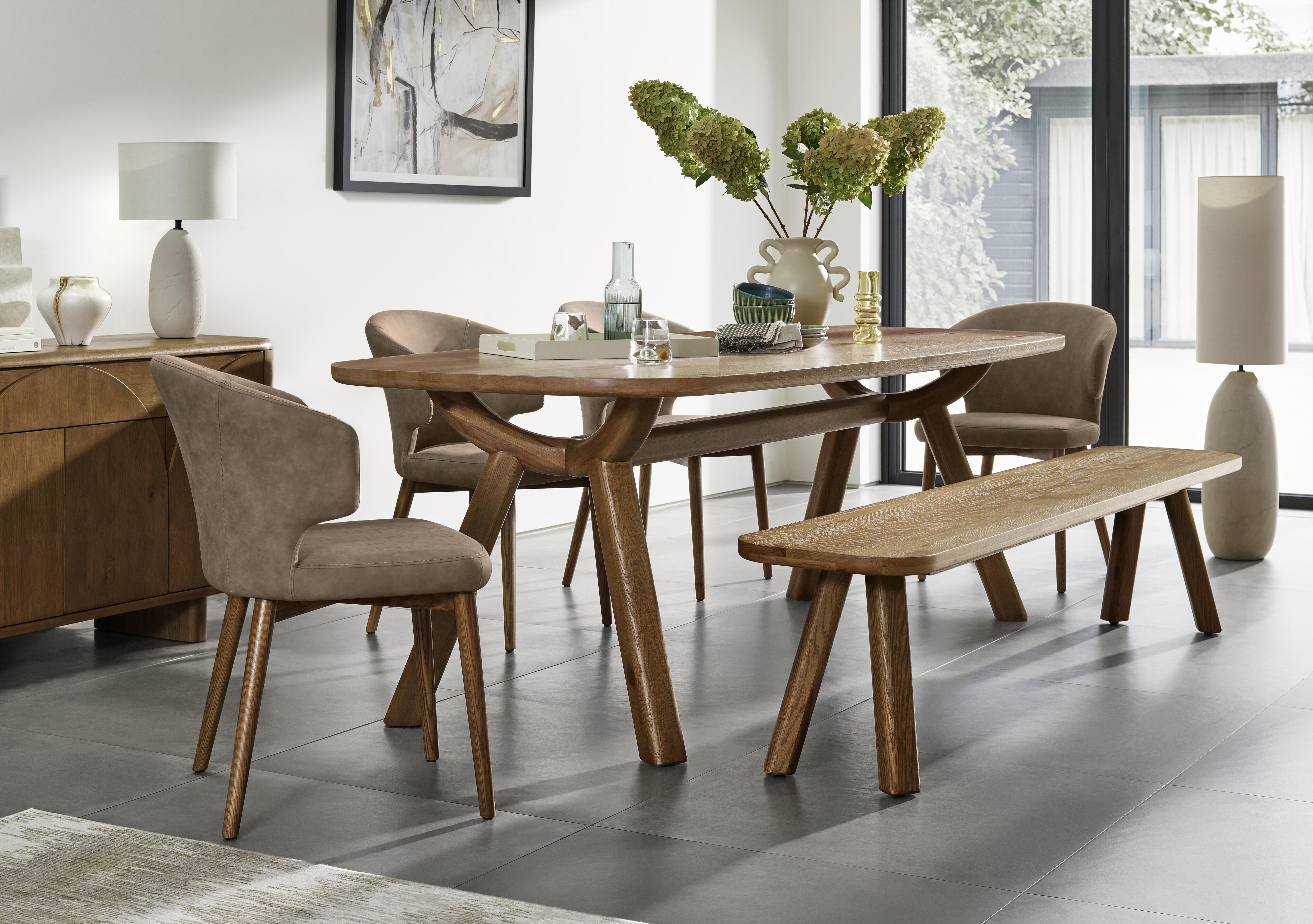 Pien Large Boat Shaped Oak Fixed Dining Table, 4 Faux Leather Dining Chairs with Wooden Legs and a Large Dining Bench in  on Furniture Village