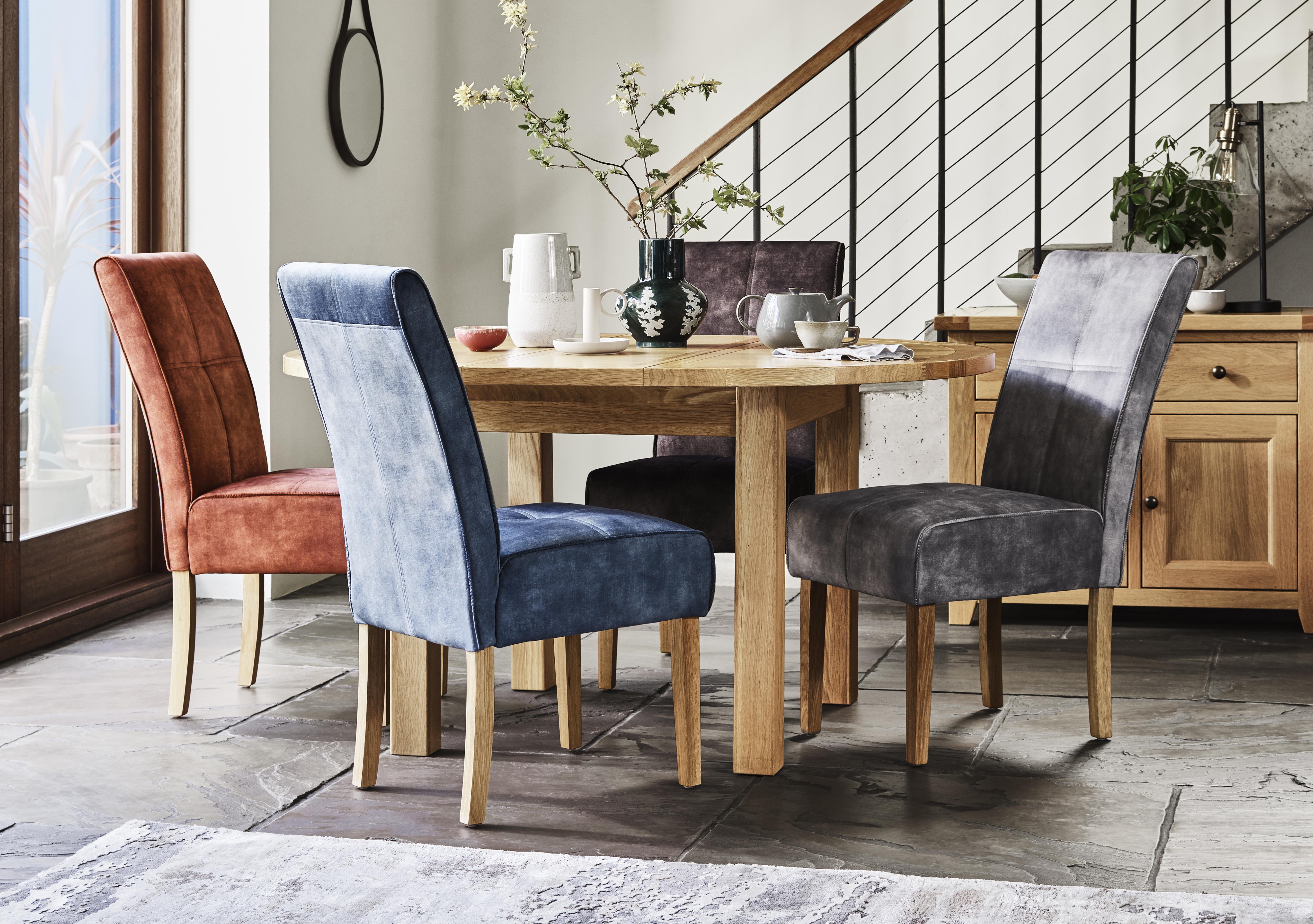 California Solid Oak Round Extending Table and 4 Velvet Fabric Dining Chairs in  on Furniture Village