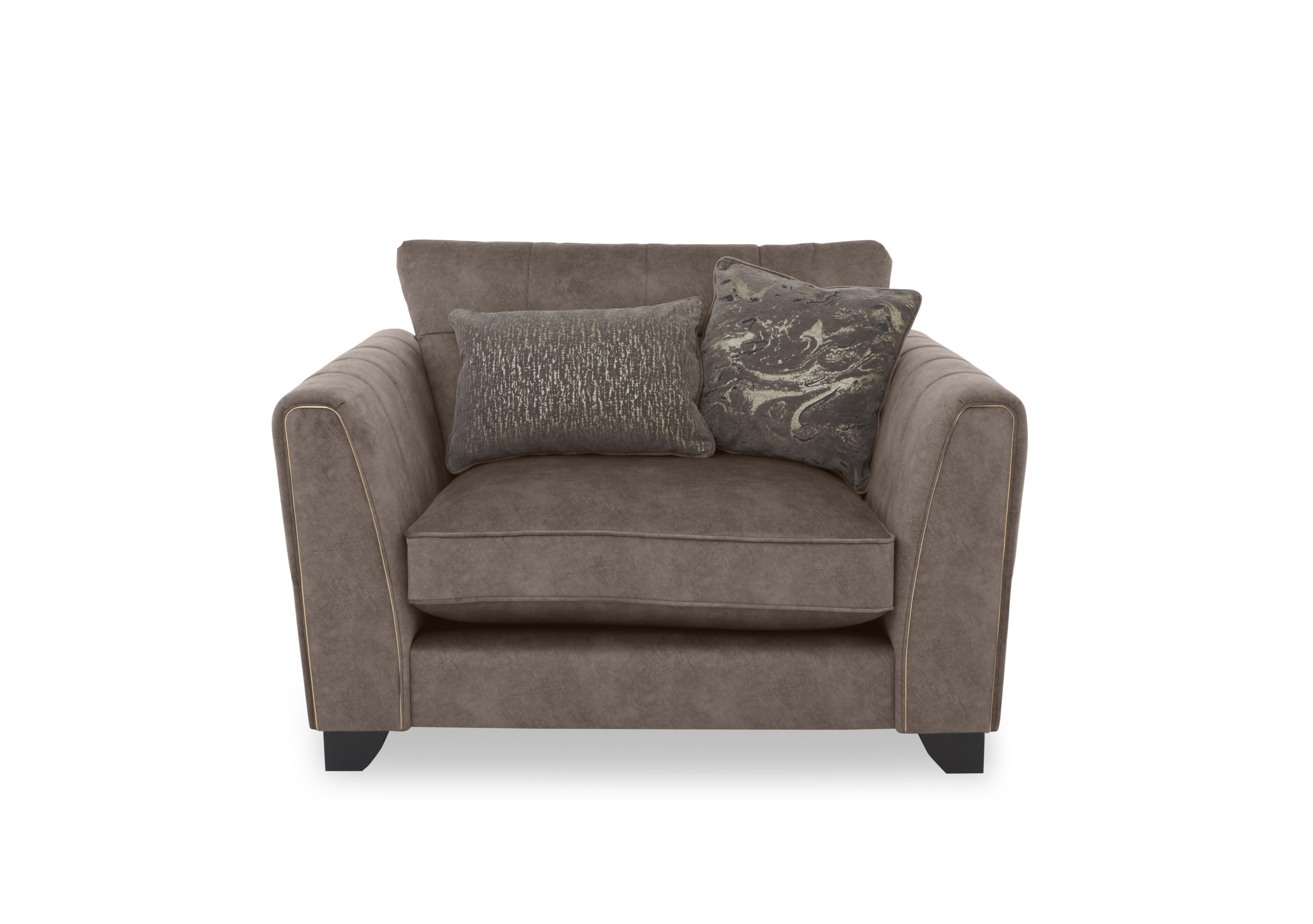 Ariana Classic Back Fabric Snuggler Chair in Chocolate Portoro Brass Trim on Furniture Village