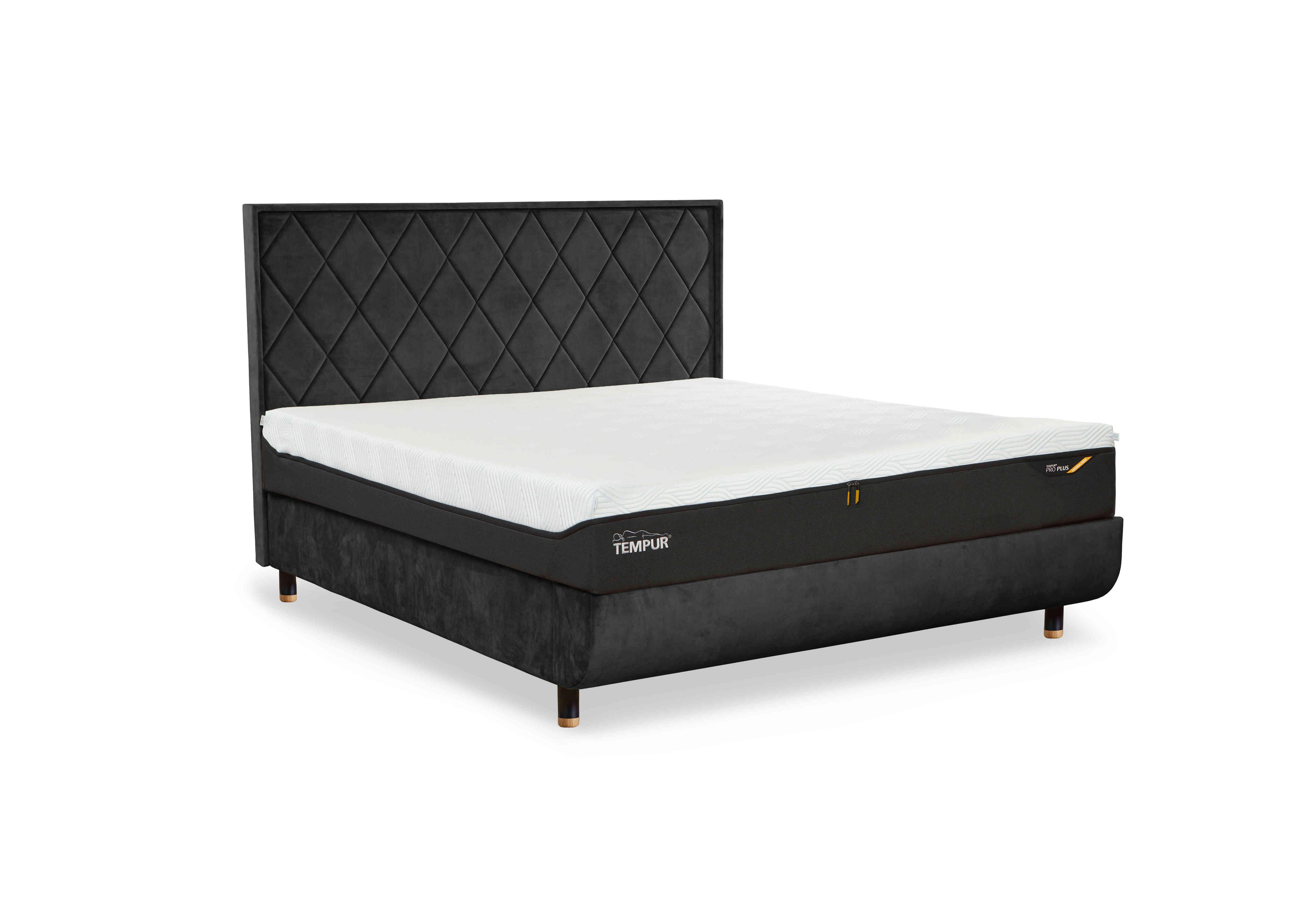 Arc Disc Ottoman Bed Frame with Quilted Headboard in Dark Grey-Black/Oak Feet on Furniture Village