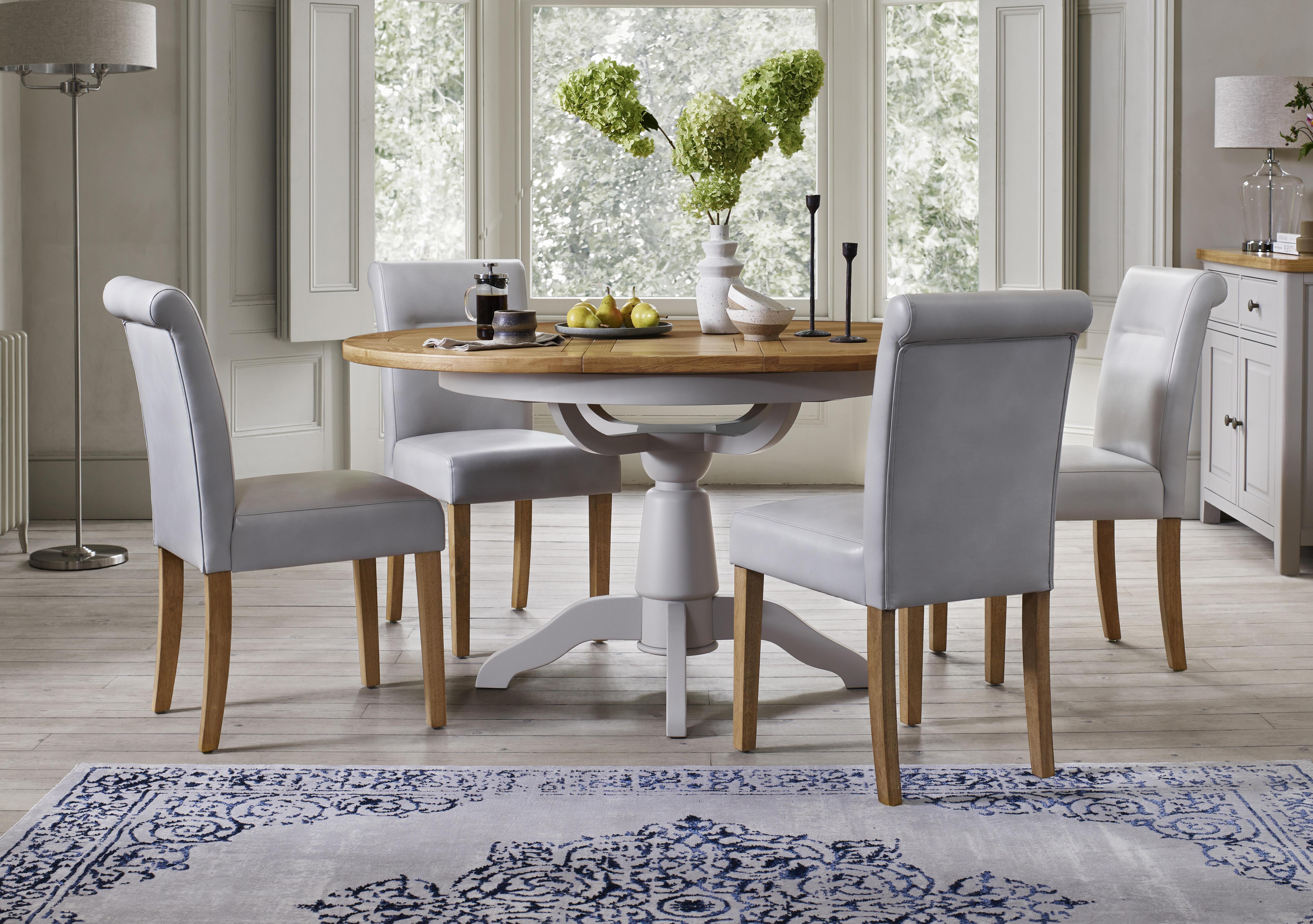 Lewis Round Pedestal Butterfly Extending Dining Table and 4 Roll Back Faux Leather Dining Chairs in  on Furniture Village