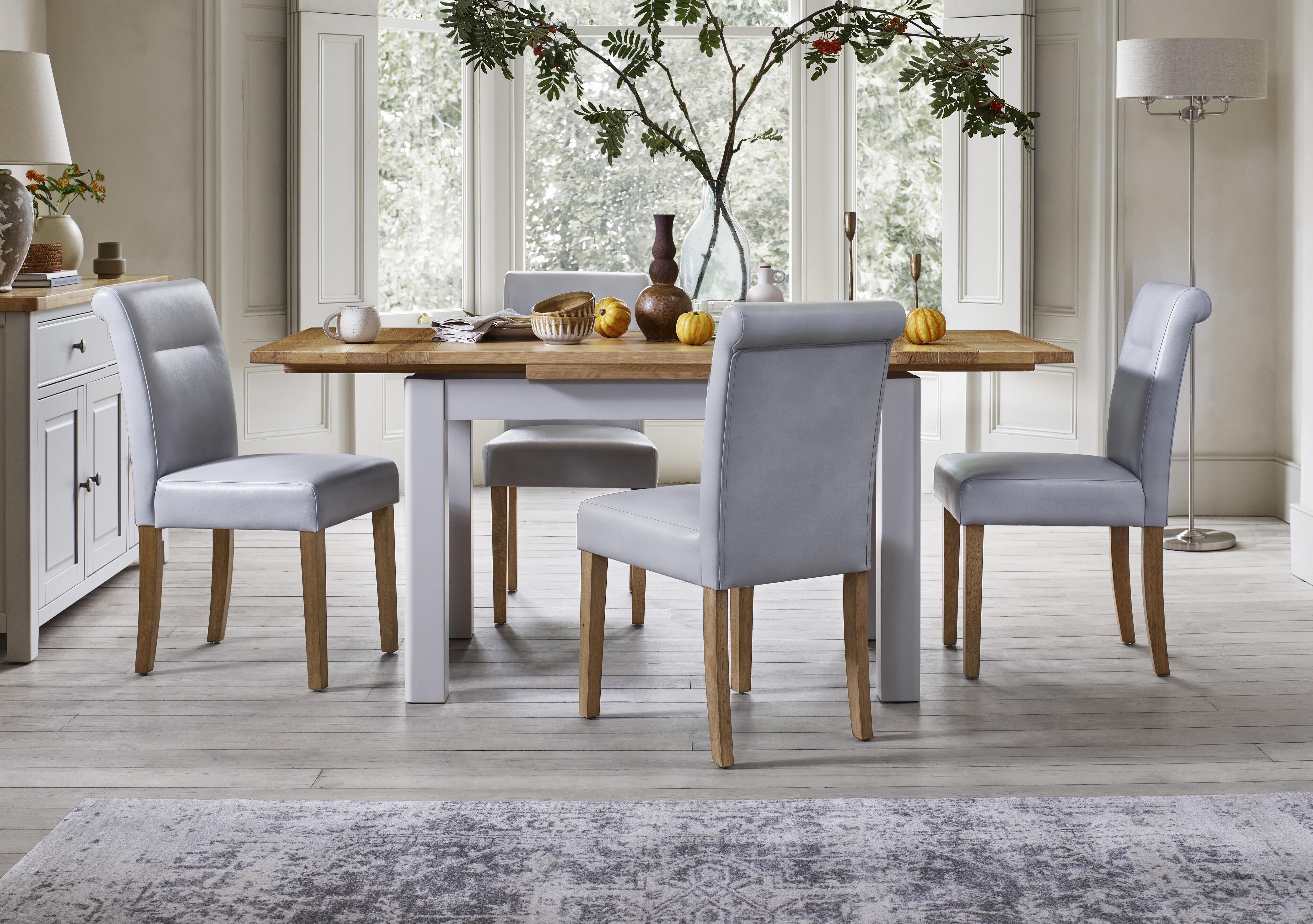 Lewis Large Draw Leaf Extending Dining Table and 4 Roll Back Faux Leather Dining Chairs in  on Furniture Village