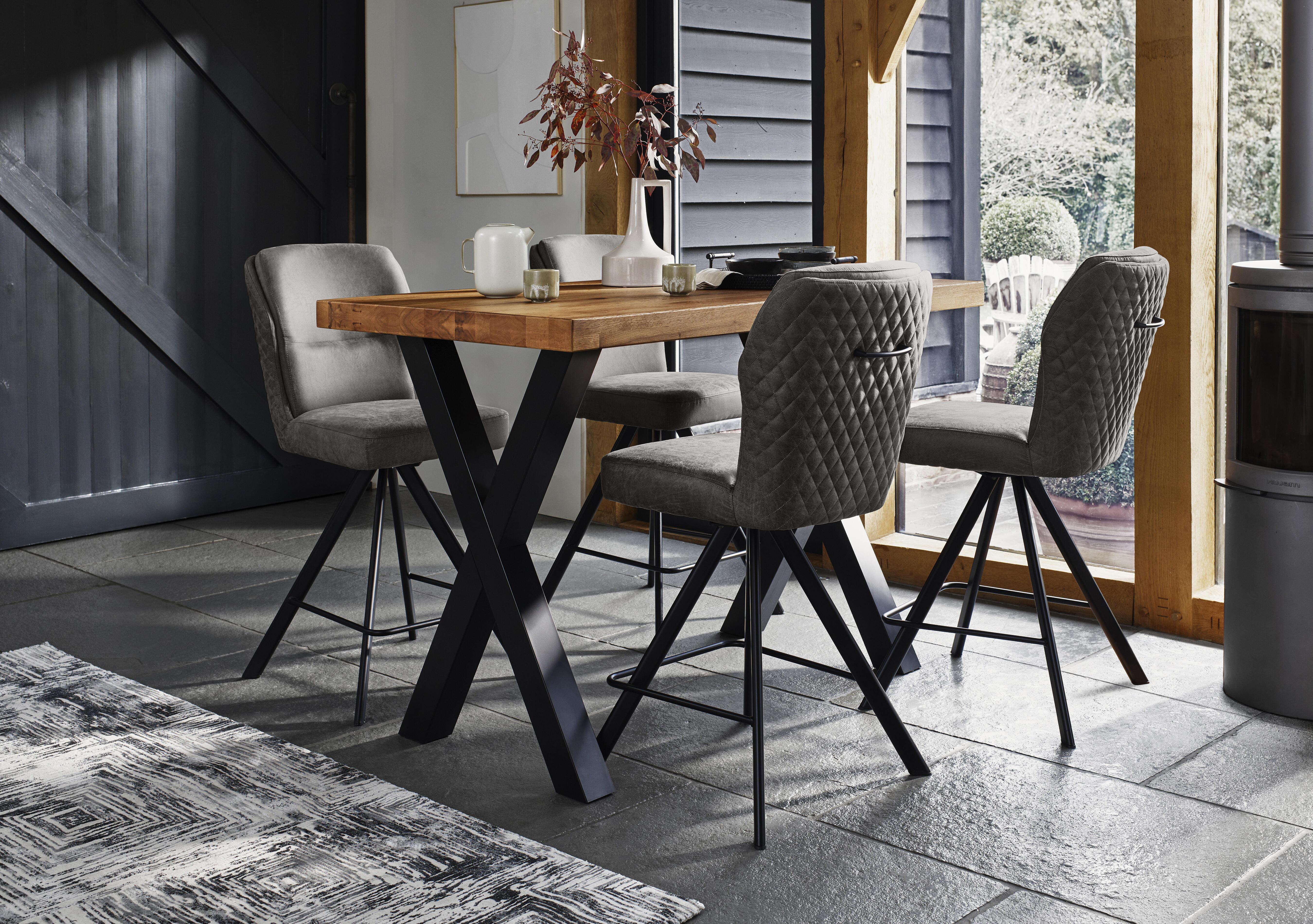 Hades 140cm Straight Edge Bar Table with X Shaped Legs and 4 Terra Steel Fabric Swivel Bar Stools in  on Furniture Village