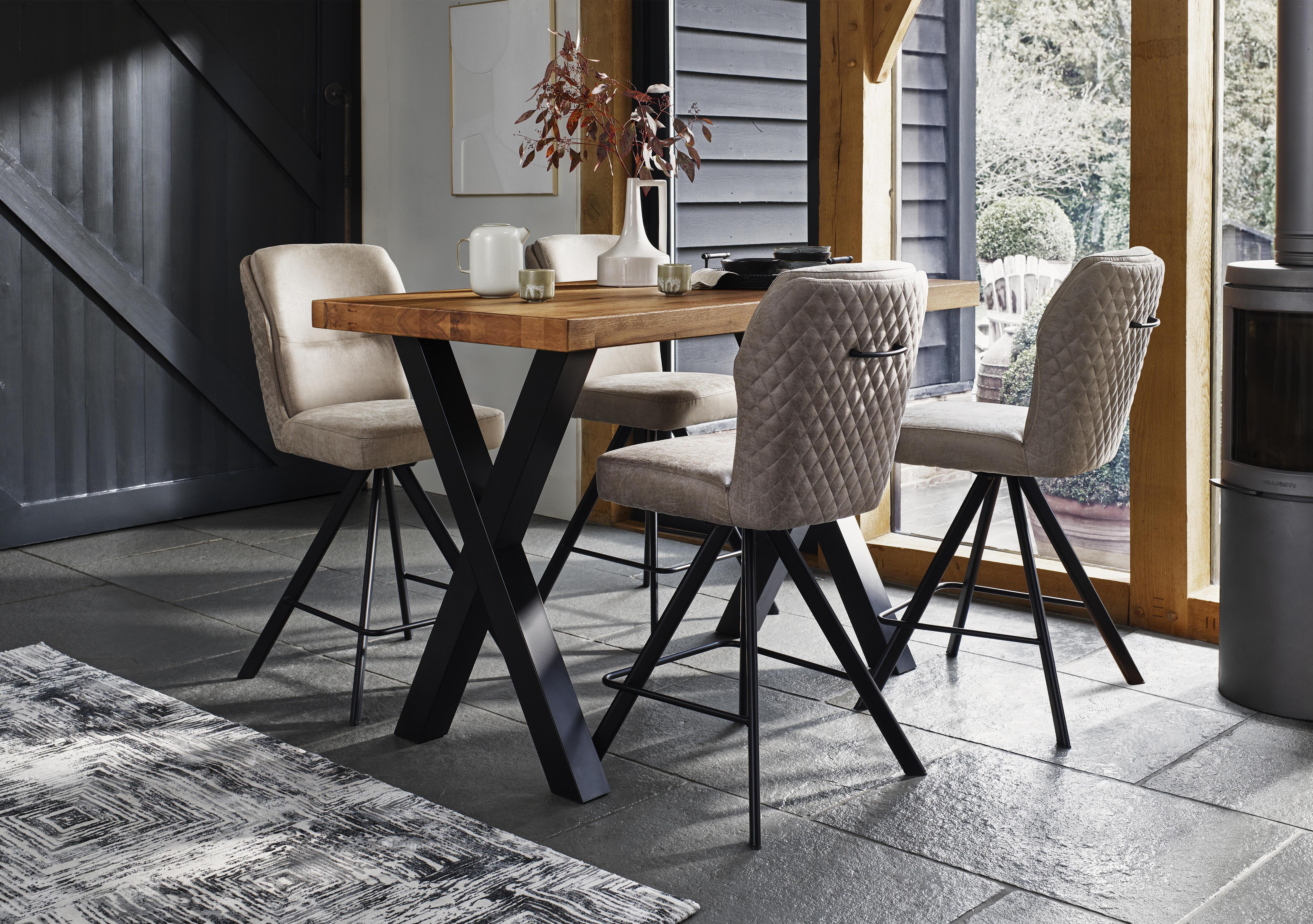 Hades 140cm Straight Edge Bar Table with X Shaped Legs and 4 Terra Taupe Fabric Swivel Bar Stools in  on Furniture Village