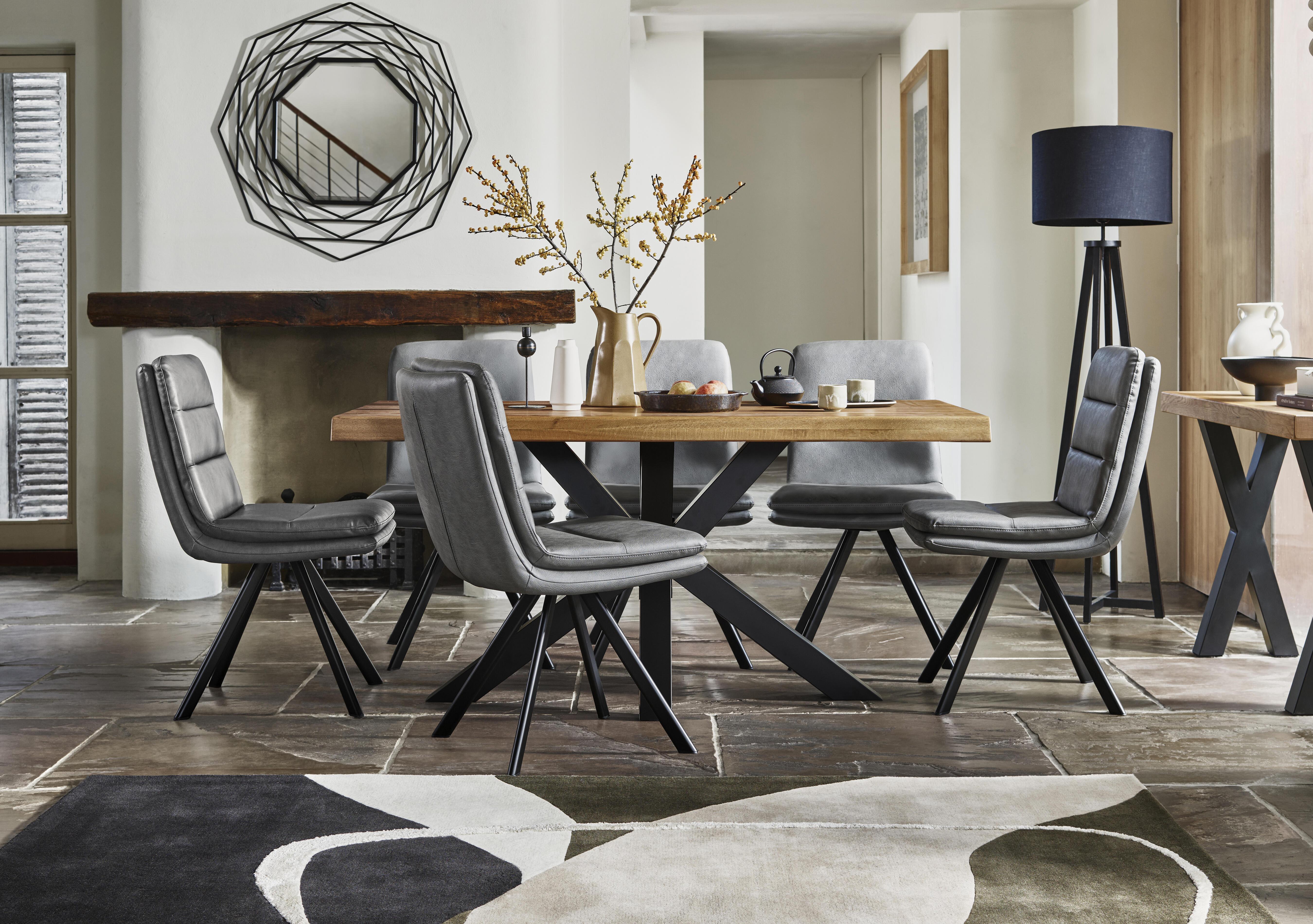 Njord 160cm Compact Raw Edge Dining Table with Metal Star Base and 6 Grey Faux Leather Swivel Dining Chairs in  on Furniture Village