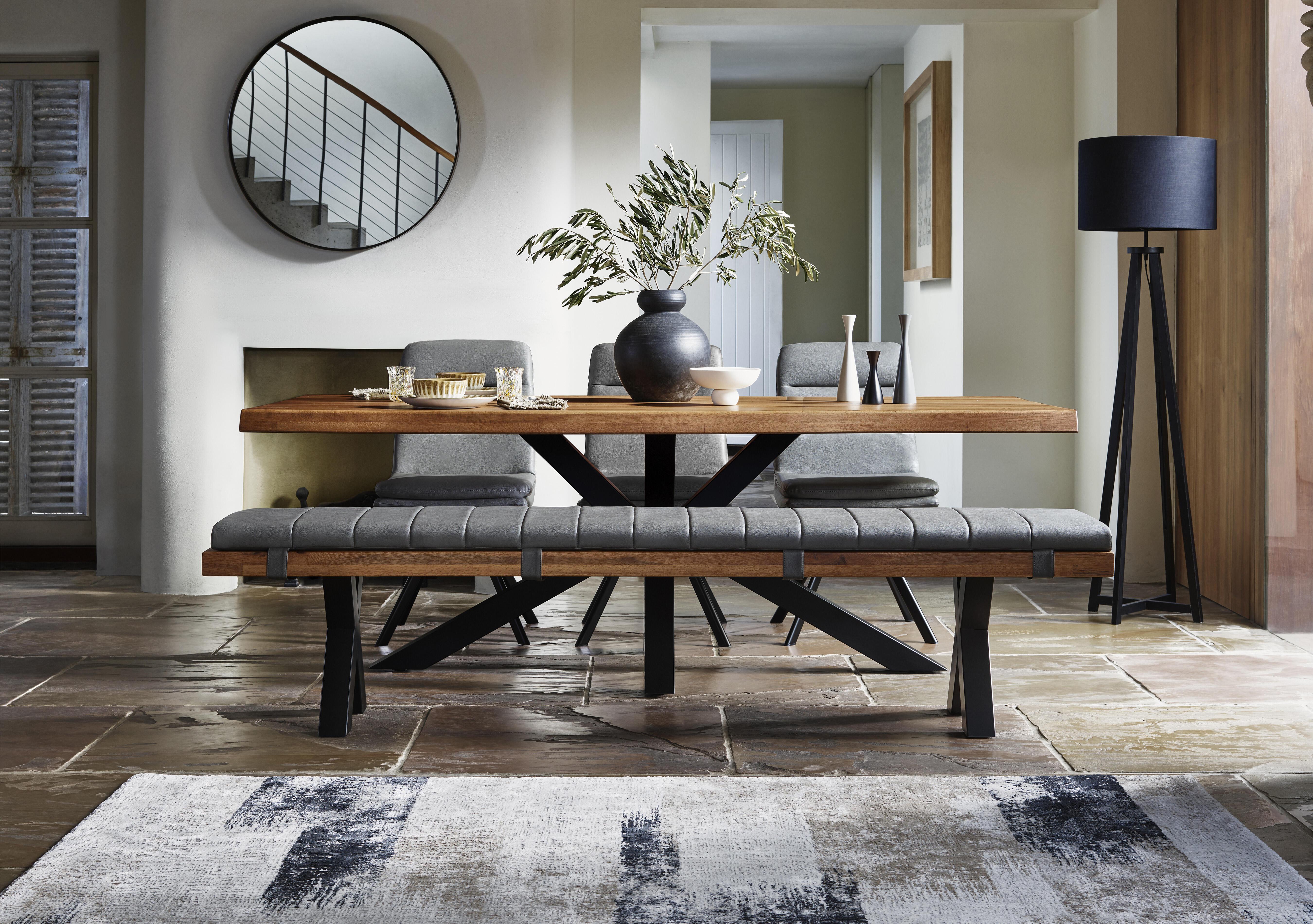 Njord Raw Edge Dining Table with Metal Star Base, Dining Bench and 3 Grey Faux Leather Swivel Dining Chairs in  on Furniture Village