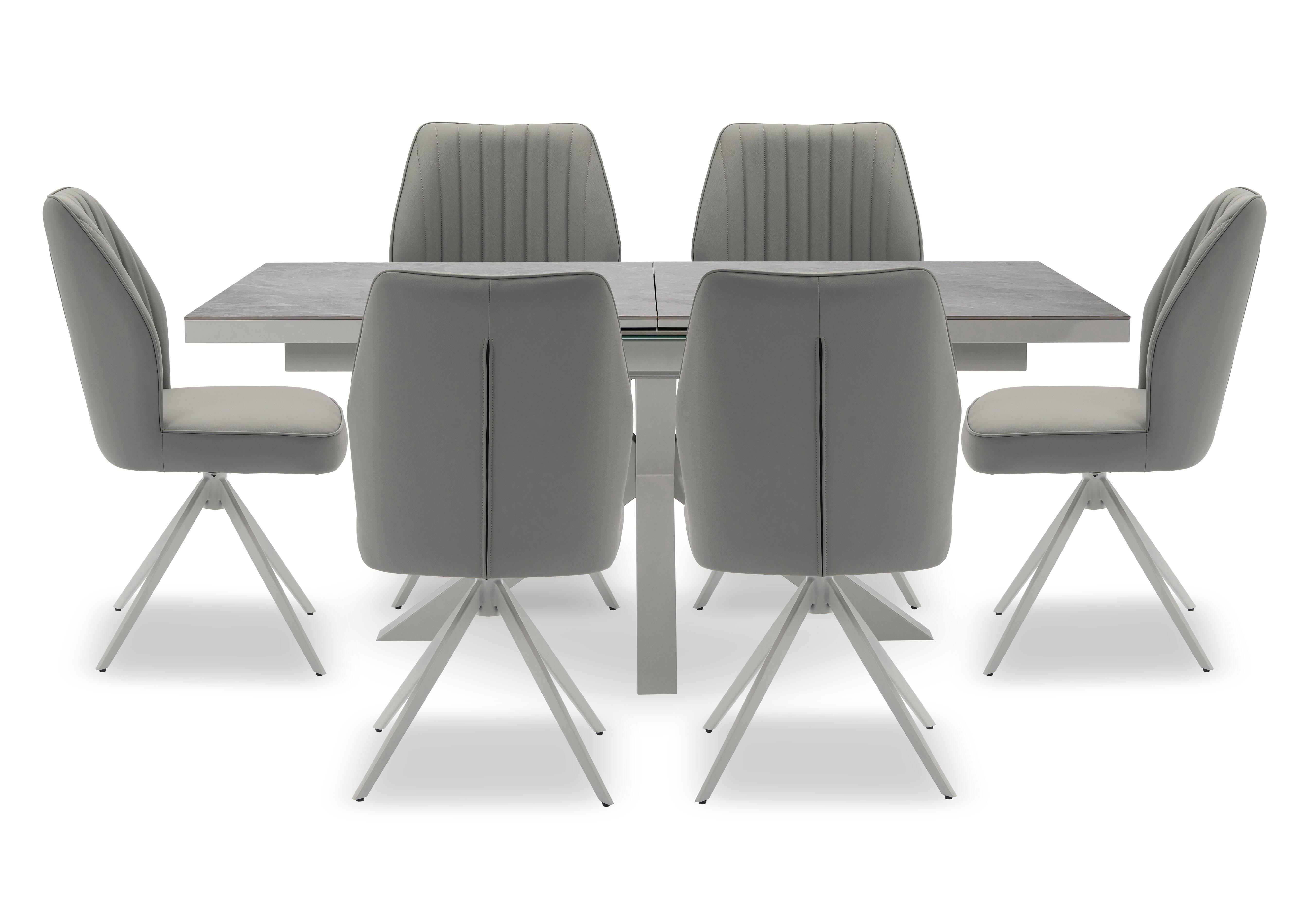 Fumo Pop Up Extending Dining Table and 6 Faux Leather Swivel Dining Chairs in  on Furniture Village