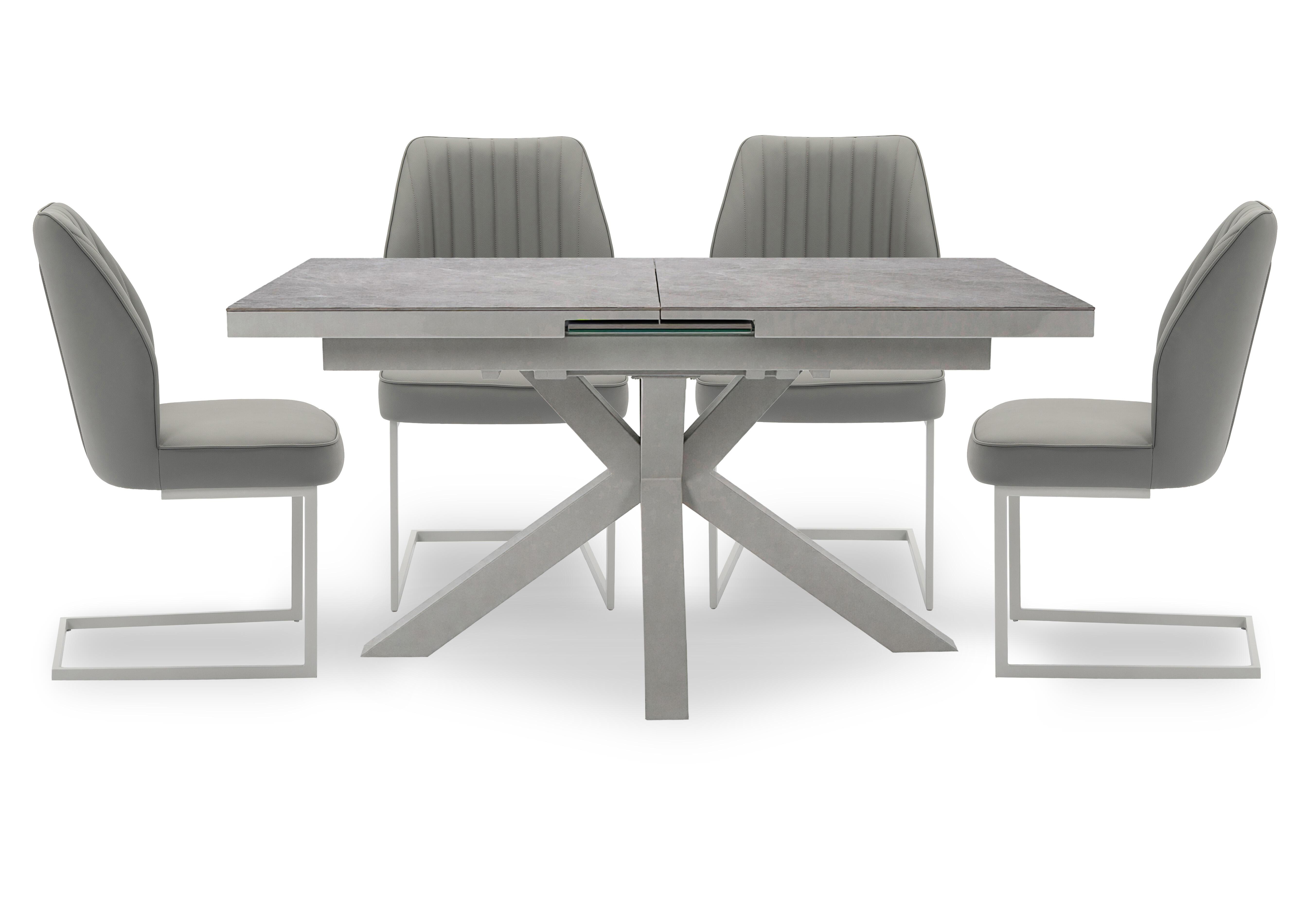 Fumo Pop Up Extending Dining Table and 4 Faux Leather Cantilever Dining Chairs in  on Furniture Village