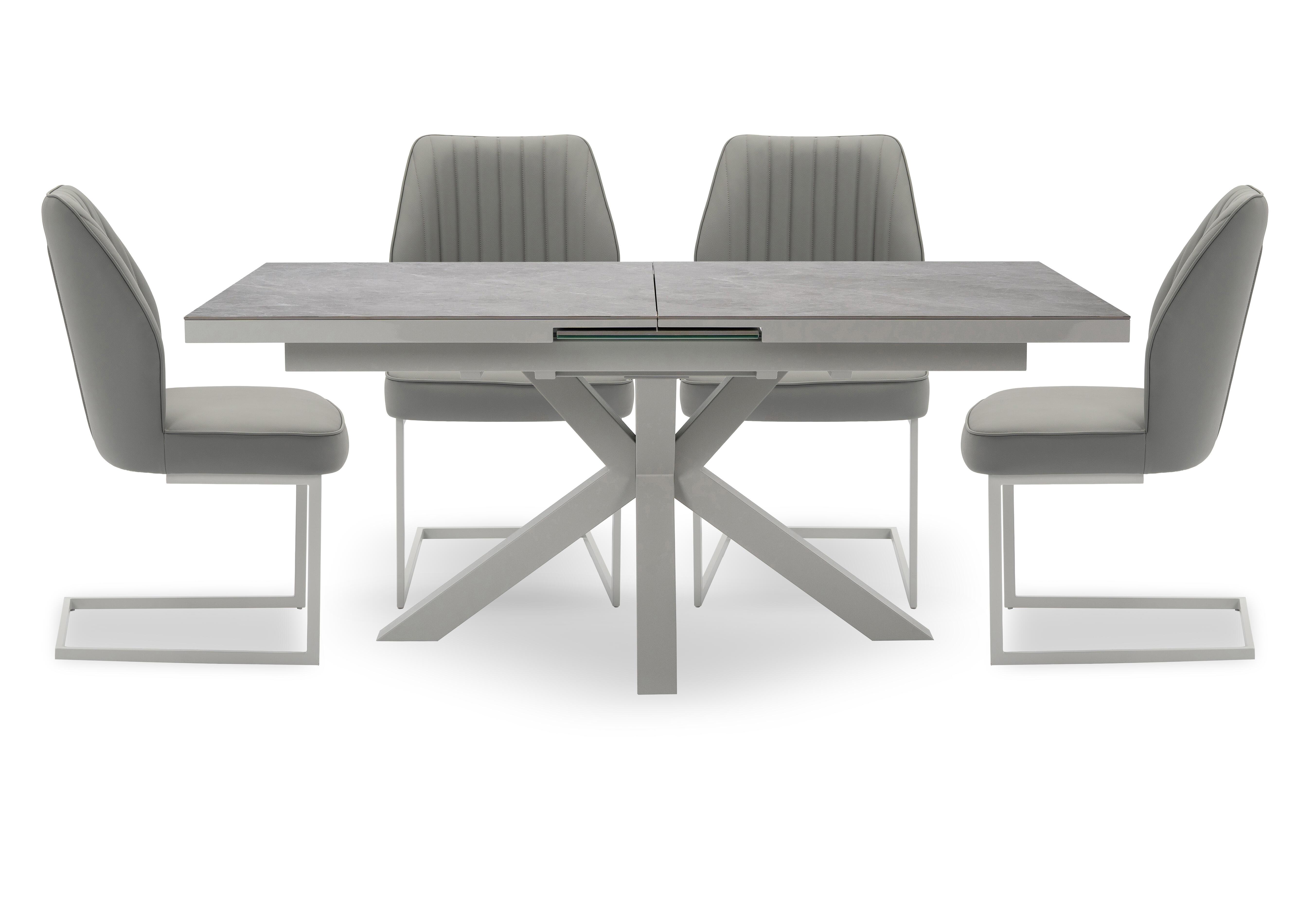 Fumo Pop Up Extending Dining Table and 4 Faux Leather Cantilever Dining Chairs in  on Furniture Village