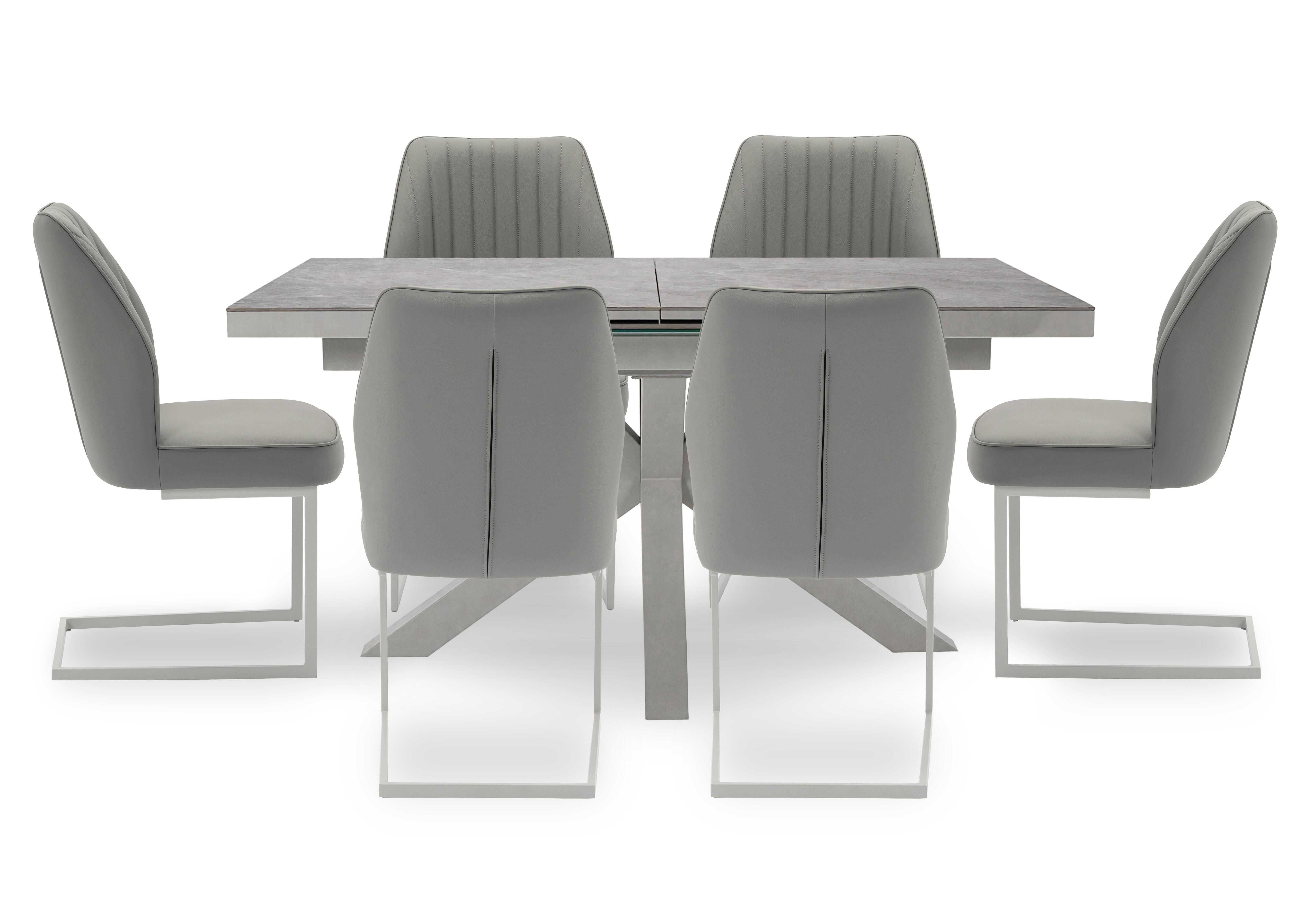 Fumo Pop Up Extending Dining Table and 6 Faux Leather Cantilever Dining Chairs in  on Furniture Village