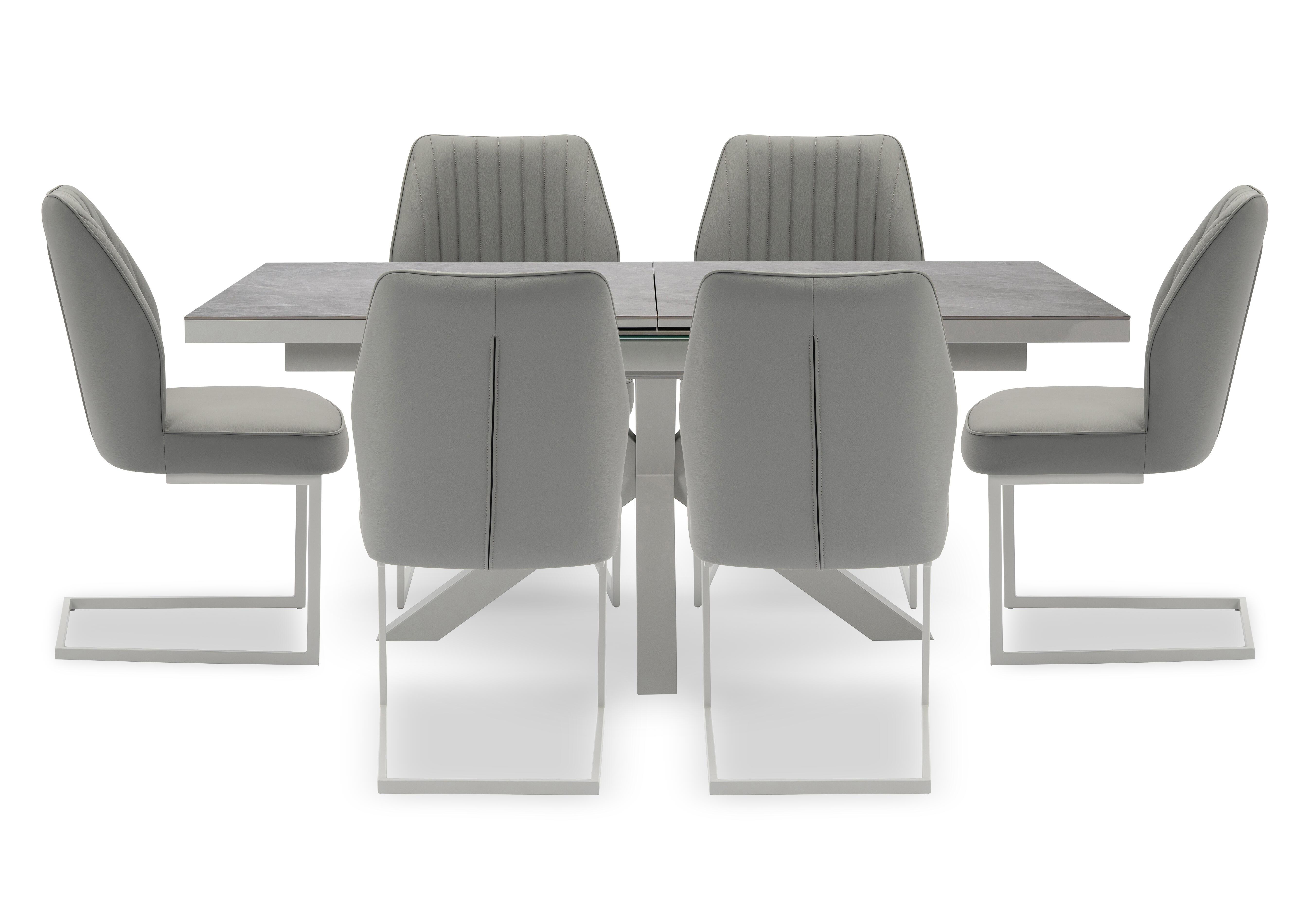 Fumo Pop Up Extending Dining Table and 6 Faux Leather Cantilever Dining Chairs in  on Furniture Village