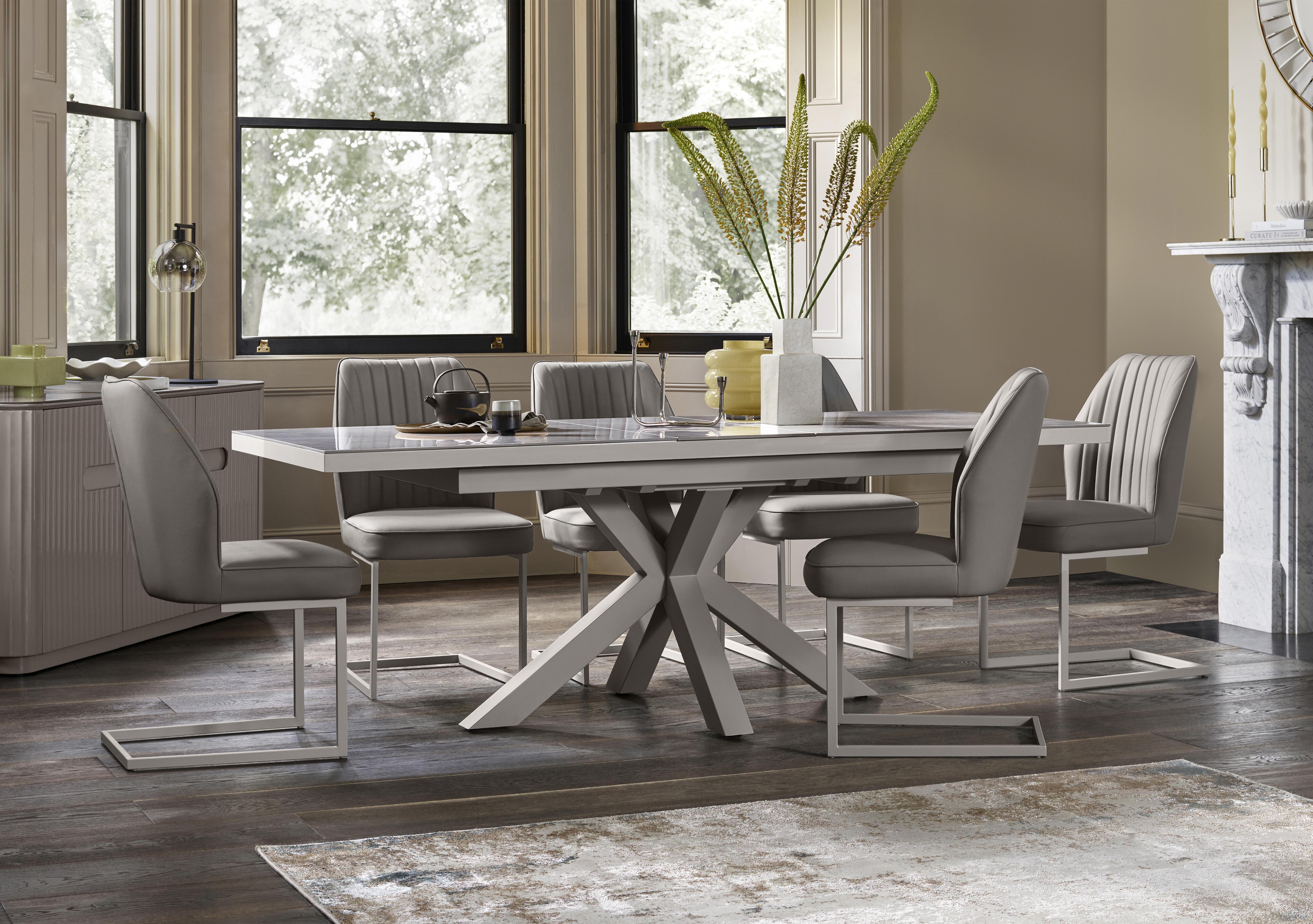 Fumo Pop Up Extending Dining Table and 6 Faux Leather Cantilever Dining Chairs in  on Furniture Village
